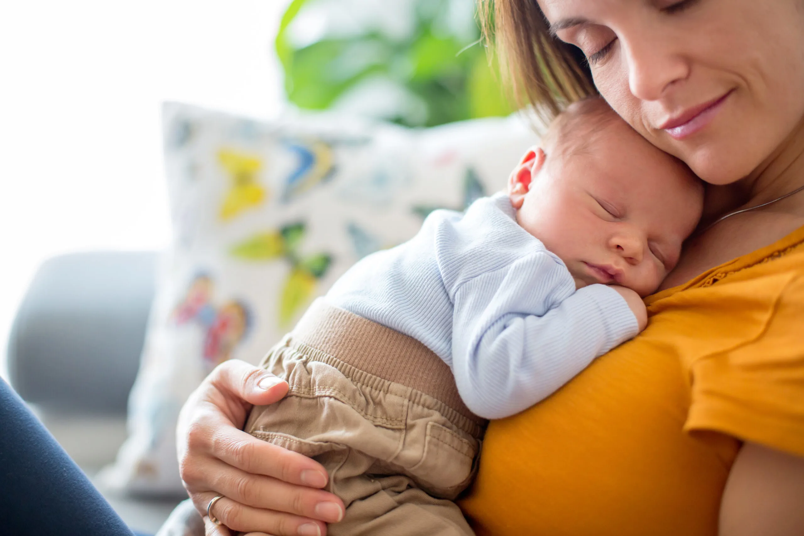 mom cuddling newborn baby